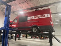 Commercial van on lift in service bay